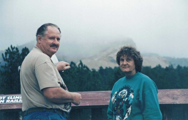 Texas tourists Gene and Helga Dickson arrived on the mountain just as Crazy Horse was shrouded in fog. (© FlaglerLive)