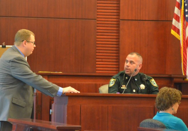 Flagler County Sheriff's deputy Diego Gonzalez, 32, being cross-examined by Assistant State Attorney Mark Lewis today, was sworn in in September 2015. (© FlaglerLive)