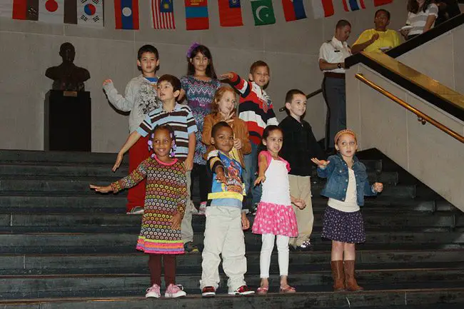 Children ages 6 to 10 performing 'God Bless America' in sign language at the an annual Diversity Day Observance at Eisenhower Hall, West Point. The observance included performances by the Cadet African-American Arts Forum, Native American Tribal Dance, Cadet Combat Salsa Club along with food samplings from various cultures. The theme was 'Diversity: The Road to Readiness.' (Kathy Eastwood)