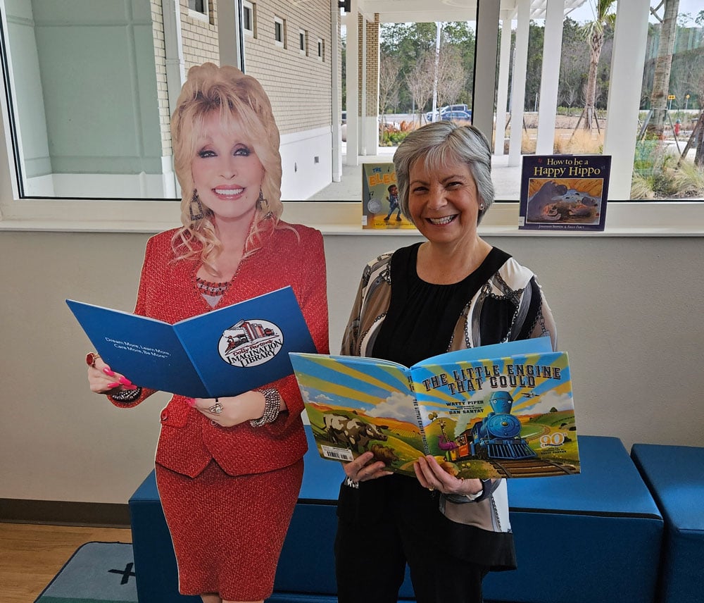 Linda Mahran, founder of the Flagler County Early Literacy Endowment, poses with a cutout of Dolly Parton, whose Imagination Library program the endowment was created to sustain — delivering free books monthly to enrolled Flagler County children from birth to age five. (Community Foundation and United Way of Volusia-Flagler Counties )