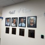 Donelle Evensen's portrait and recognition plaque, second from left, as the reigning assistant principal of the year, on the district's Wall of Fame outside the superintendent's suite at the Government Services Building. (© FlaglerLive)
