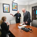 Doug Thomas, center, executive vice president of SGR, the executive recruiting firm, setting up one of the one-on-one interviews of candidate Rich Hough with City Council member Theresa Pontieri at City Hall last week. (© FlaglerLive)