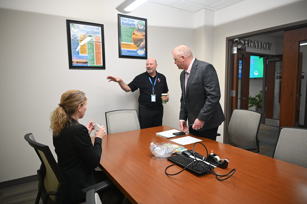 Doug Thomas, center, executive vice president of SGR, the executive recruiting firm, setting up one of the one-on-one interviews of candidate Rich Hough with City Council member Theresa Pontieri at City Hall last week. (© FlaglerLive)