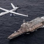 A U.S. surveillance drone flies over the USS Coronado in the Pacific Ocean during an April 2021 drill. (U.S. Navy/Chief Mass Communication Specialist Shannon Renfroe)