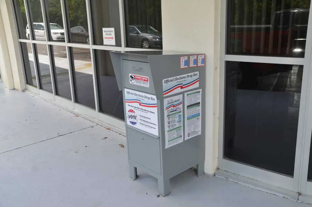 Back in the old days when a drop-box didn;t have to be attended, and could take ballots 24 hours. The Legislature and Gov. Ron DeSantis changed that law, restricting the location and availability of ballot boxes and increasing their costs to supervisors of election. (© FlaglerLive)