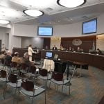 Facilitator Georgette Dumont, with members of the Charter Review Committee behind her, presenting the committee's work, now taking shape in final form at the council's hands. (© FlaglerLive)