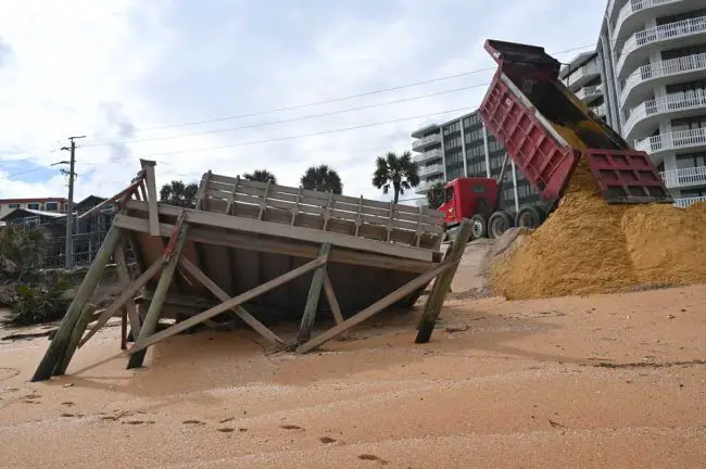 One of the dozens of trucks that dumped sand all day today. (© FlaglerLive)