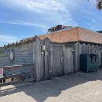 The dumpster enclosure outside the Funky pelican in Flagler Beah has needed repairs for years. The city commission voted to award a bid for those repairs. It did not know that it was also voting to expand the dumpster area, further blocking the view of the ocean to the north of the restaurant. (© FlaglerLive)