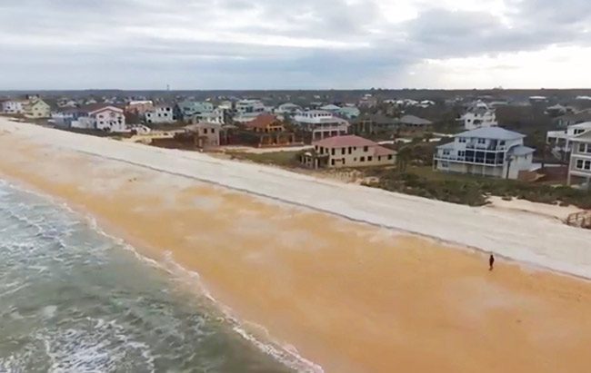 The new runway-like layer of dunes, its sand quality distinctly whiter than existing sand, lines the edge of the beach in a capture from Chris Goodfellow's drone.