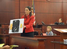 Assistant State Attorney Jennifer Dunton shows the jury the five-shot revolver, a .22-caliber Magnum, which the prosecution says is the murder weapon. click on the image for larger view. (c FlaglerLive)