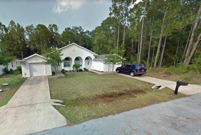 The duplex at 12A Bunker Knolls in Palm Coast, and Tyrone Hartley's GMC in the driveway. 