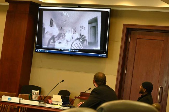 DuPree, right, and the man the prosecution says was DuPree, pointing a gun at one of the victims during the robbery in DEcember 2020 in a surveillance clip repeatedly played during the trial. (© FlaglerLive)