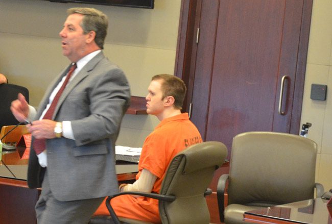 Paul Dykes, seated, as his public defender, Bill Bookhammer, spoke to Circuit Judge Dennis Craig during a hearing at the Flagler County courthouse this afternoon. (© FlaglerLive)