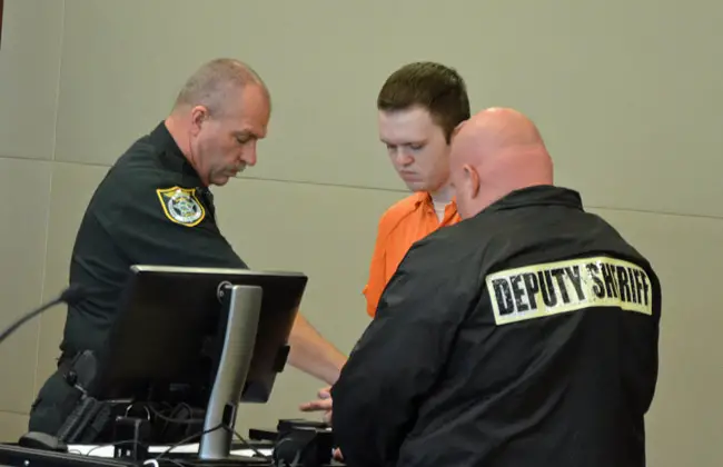 Paul Dykes being fingerprinted after Circuit Judge Dennis Craig pronounced a life sentence this morning at the Flagler County courthouse. (© FlaglerLive)