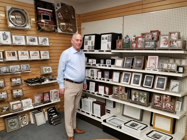 Richard Master, CEO of MCS Industries in Easton, Pa., stands in a showroom of the company's picture frames and wall decor. He says one of the biggest impediments to keeping labor costs in line has been the increasing expense of health coverage in the United States. (Phil Galewitz/KHN)