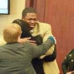 Edward "Ed Boy" Sampson hugging Assistant Public Defender CVourtney Davison, with Assistant Public Defender Melissa right behind her. (© FlaglerLive)