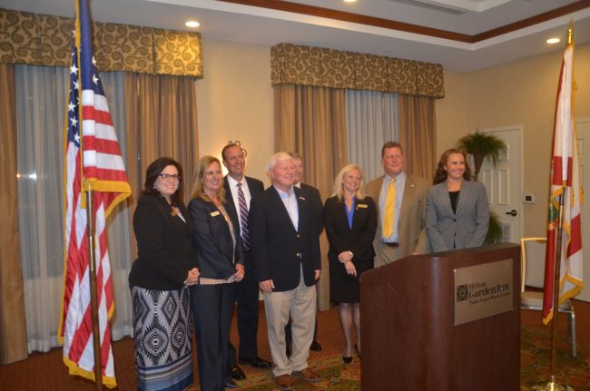 Ed Fuller, center, with the judges. From left, Mary Jolly, Leah Case, R. Lee Smith, Fuller, Terence Perkins, Elizabeth Blackburn, Chris France and Melissa Moore-Stens. Click on the image for larger view. (© FlaglerLive)