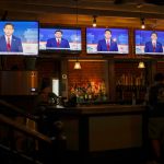 GOP presidential candidate Ron DeSantis on television screens at a Washington, D.C. bar during the first 2024 Republican presidential primary debate on Aug. 23, 2023.