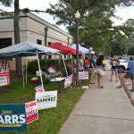 Tents and candidates on the final day of the primary outside the public library in Palm Coast. (© FlaglerLive)