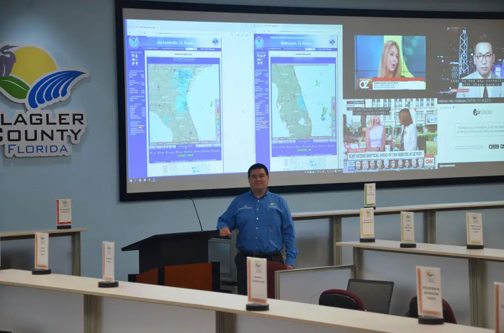 Flagler County Emergency Management Chief Jonathan Lord. When fully activated, the Emergency Operations Center, where Lord is standing, previously drew 60 to 70 people. That won;t be the case in Covid-affected emergencies, when the EOC will top off at 20 to 30 people, with others working remote. (© FlaglerLive)