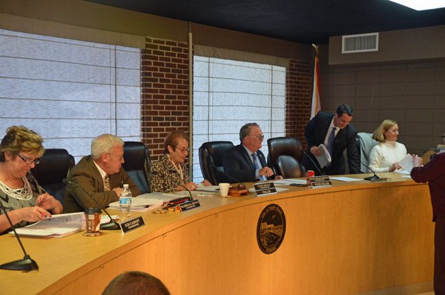 Eric Cooley, second from right, getting ready to take his commission seat for the first time after being sworn-in on March 8. (© FlaglerLive)