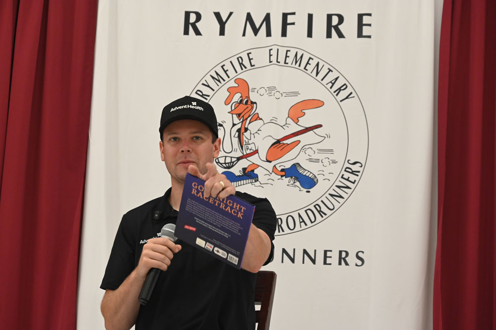 Erik Jones on Friday, doing one of his favorite things away from the track: reading to children. (© FlaglerLive)