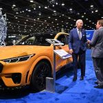 President Joe Biden speaks with Ford Motor Co. Executive Chairman William Clay Ford Jr. beside an electric Mustang.