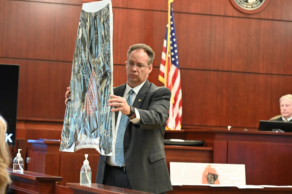 ASA Mark Johnson showing the jury the pants that Marcus Chamblin wore the night he shot and killed (© FlaglerLive)