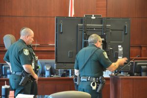 Much of the state's evidence against Vickers is actual video footage that she is accused of shooting, and that will be shown to the jury. Bailiffs prepared the television screen for testing after the jury was dismissed. (© FlaglerLive)