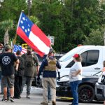 Far-right extremists, some in camouflage, some belonging to the Three Percenters, the anti-government militia, preparing to enter the Flagler County School Board meeting last month in Bunnell. (© FlaglerLive)