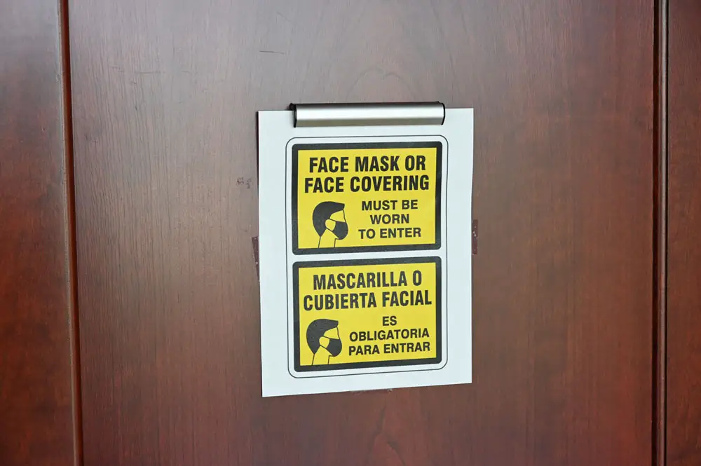 Signs about mandatory face-masking were still posted at the Flagler County courthouse last week, but in the courtrooms, judges were relaxing the rules.. making masks optional. (© FlaglerLive)