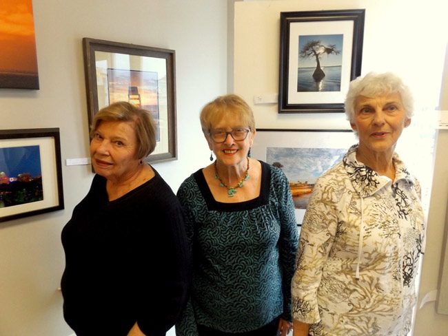 Flagler County Art League members Joan Mangano , right, current president Ann DeLucia (middle) and Joan Howard at the Flagler County Art League's gallery and studio in City Market Place in Palm Coast. The art league celebrates its 40th anniversary this year. (© FlaglerLive)