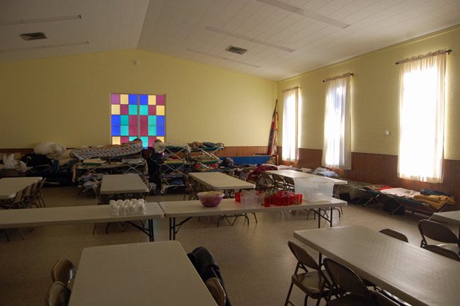 Cots and tables at Fellowship Hall, at Bunnell's United Methodist Church, which becomes a cold-weather shelter for the homeless on certain nights. (© FlaglerLive)