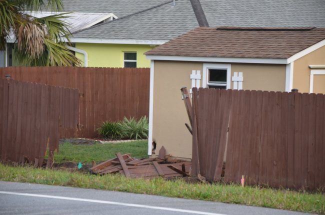 The fence the car took out after striking the pole. (© FlaglerLive)