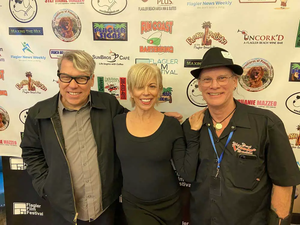 * “D.O.A.” director Kurt St. Thomas, left, and cast member Annie Gaybis pose with Flagler Film Festival director Tim Baker following the screening of the film noir drama. (© FlaglerLive)