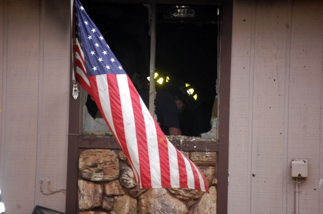 The fire started on the bed in the bedroom of the unit at The Village. Somehow, Old Glory escaped with only a few scrapes. (© FlaglerLive)