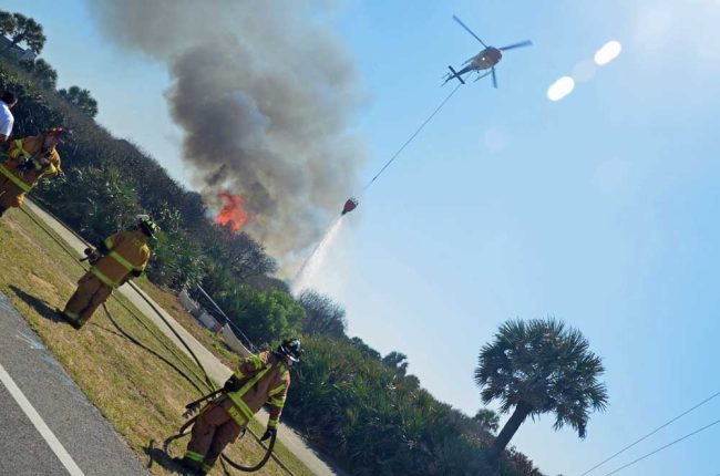 FireFlight controlling a fire on the barrier island in 2013. (© FlaglerLive)