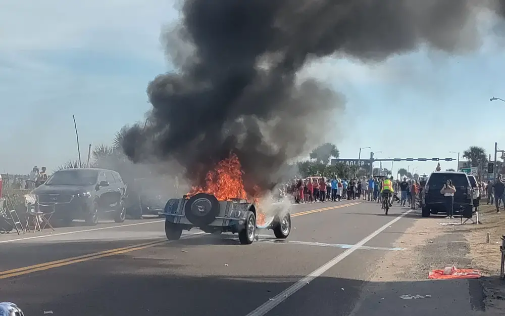 The Jaguar, an exact replica of a 1930s model, caught fire toward the tail end of the Holiday Parade this afternoon in Flagler Beach. (© FlaglerLive)