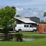 The company had positioned vehicles against the burnt building to block its view at Santore and Sons in West Flagler. (© FlaglerLive)