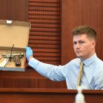 Former Flagler County Sheriff Crime Scene Investigator Daniel Wardman shows the jury the firearm, a BDA 380 semi-automatic pistol, that Brennan Hill hid after shooting Savannah Gonzalez in his car in March 2021. Hill is on trial for second degree murder. His attorney says the shooting was accidental. (© FlaglerLive)