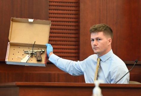 Former Flagler County Sheriff Crime Scene Investigator Daniel Wardman shows the jury the firearm, a BDA 380 semi-automatic pistol, that Brennan Hill hid after shooting Savannah Gonzalez in his car in March 2021. Hill is on trial for second degree murder. His attorney says the shooting was accidental. (© FlaglerLive)