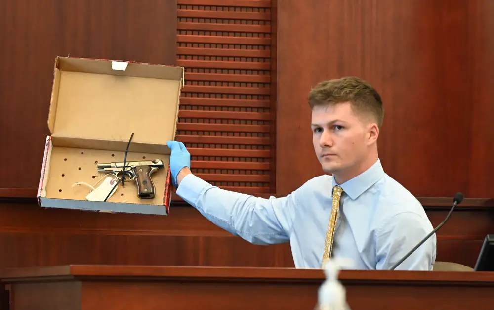 Former Flagler County Sheriff Crime Scene Investigator Daniel Wardman shows the jury the firearm, a BDA 380 semi-automatic pistol, that Brennan Hill hid after shooting Savannah Gonzalez in his car in March 2021. Hill is on trial for second degree murder. His attorney says the shooting was accidental. (© FlaglerLive)