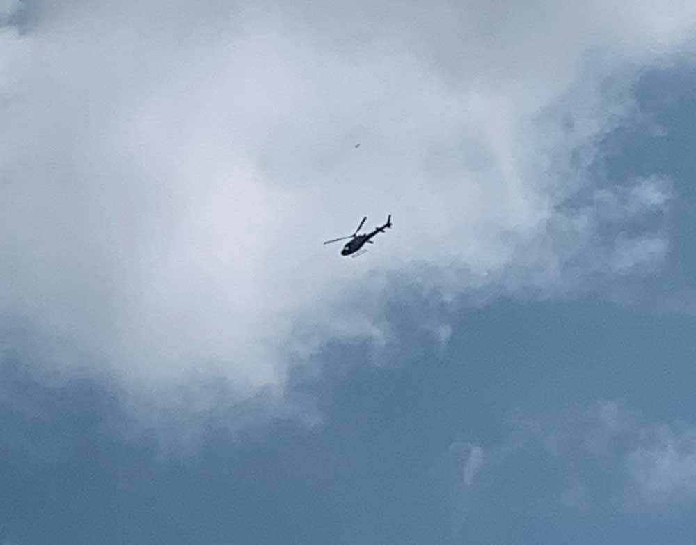 Flagler County FireFlight, the emergency helicopter, hovering over Matanzas High School around noon today. (© FlaglerLive)