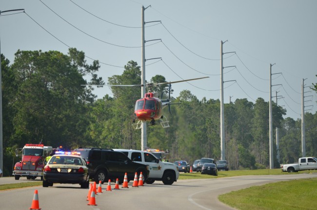 Flagler County Fireflight, the emergency helicopter, takes off from the northbound lanes of U.S. 1 at 5:30 this afternoon, with the victim of the motorcycle wreck onboard. Click on the image for larger view. (c FlaglerLive)