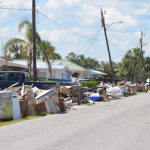 A street in Flagler Beach lined with furniture ruined by floods caused by Hurricane Irma in September 2017. (© FlaglerLive)