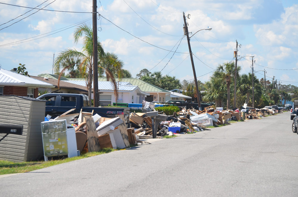 A street in Flagler Beach lined with furniture ruined by floods caused by Hurricane Irma in September 2017. (© FlaglerLive)