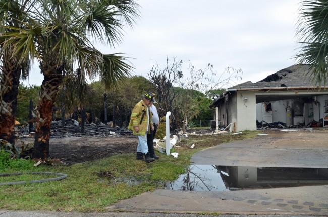 Number 208 was to the left, 210 is to the right, with Flagler Beach City Commissioner Marshall Shupe, who is also a volunteer fireman and was a fire inspector, speaking with a state official this morning. Click on the image for larger view. (© FlaglerLive)