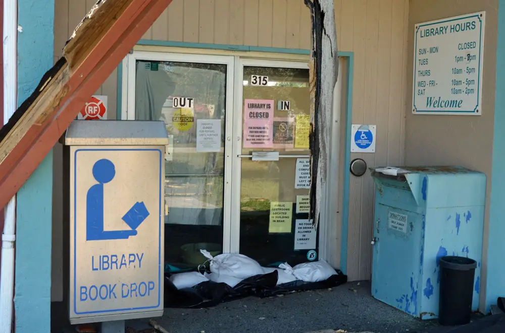 The Flagler Beach library, seen here in the aftermath of Hurricane Irma in 2017, has had it rough for the past few years, but has remained open more than not, one way or another. It reopens its doors to in-person browsing Tuesday. (© FlaglerLive)