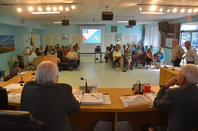 Flagler Beach City Commissioners, seen here moments before the start of this evening's meeting, eventually faced about 60 residents and busines owners, almost all of whom opposed a proposal to impose paid parking in the city. (c FlaglerLive) 