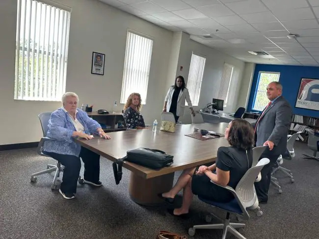 The School Board huddling in the superintnedent's office after her press conference this morning. Clockwise from left, Cheryl Massaro, the board chair, Colleen Coklin, Moore, Will Furry and Christy Chong. (© FlaglerLive)